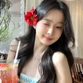 Red fabric flower hair clip worn by a model in a sweet vacation style for elegant hair decor. - Duckbill Clip (Single Piece) / Red
