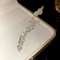 Close-up detail of a sparkling marquise zircon leaf open ring in a cream jewelry box - Silver