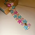 Macro shot of a luxurious 18k gold-plated zircon flower bracelet with colorful stones - Pink & Blue Zirconia Bracelet