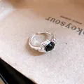 Close-up detail of the vintage silver open ring featuring a polished oval black stone - Oval Black Stone Style / Silver