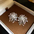 Detail view of firework-inspired pearl earrings with sparkling zircon stars in a gift box - Steel Pin Style / Silver