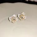 Close-up of elegant rose flower stud earrings with heart crystal and micro pearls - Silver-White