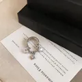 Detailed view of silver double-layered ear cuff with zircon star charm pendant - Single Piece / Silver