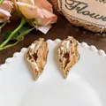 Exaggerated textured gold metallic leaf stud earrings in a vintage Western style - Gold
