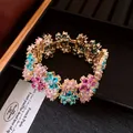 Close-up of luxury 18k gold plated flower bracelet with pink and blue zircons - Flower Open Bracelet / Gold-Multicolor Zircon