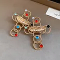 Detail view of a vintage gold cross pendant featuring a lip motif and colorful resin beads - Lip Cross Earrings (Silver Earring Post) / Gold