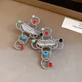 Detailed view of silver-tone cross necklaces with lips design and colorful beads - Lip Cross Earrings (Silver Earring Post) / Silver