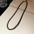Close-up of an elegant black rhinestone choker with sparkling square-cut crystals. - Necklace / Gunmetal