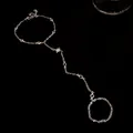 Detailed view of silver star slave bracelet featuring sparkling zircon stones on black background. - Silver