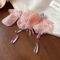 Close-up of pink chiffon flower earrings with zircon and glass water drop tassels - Pink