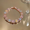 Macro detail of a rose gold bracelet with pastel rectangular zircons and pave accents - Rose Gold