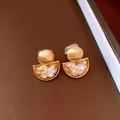 Detailed view of French vintage semi-circle clip earrings with champagne crystals - Clip-on - Gold - Coffee