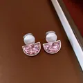 Macro view of French retro semi-circular clip-on earrings with pink faceted stones - Silver & Pink