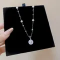 Detailed macro view of a silver pearl necklace with a star zircon pendant on black velvet - Round Starburst Style (HN12592) / Silver