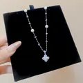 Detailed view of elegant silver flower pendant necklace with pearls and sparkling zircons. - White Four-Petal Flower Style (HN12545) / Silver