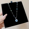 Close-up of elegant silver necklace with blue square zircon pendant on black velvet - Blue Square Style (HN12581) / Silver