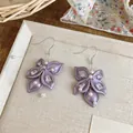 Close-up of purple petal earrings with zircon and pearls in elegant Korean style - Earring Hooks / Purple