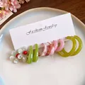 Detail of multi-piece resin earring set featuring green and pink hoops on jewelry card. - 5 Pairs Set / Pink, Green