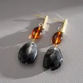 Macro detail of vintage resin drop earrings with black marbled and amber beads - Coffee-Black