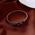 Detailed macro shot of vintage multi-row elastic open bangle with elegant black rhinestones - Bangle / Gunmetal