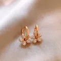 Detailed view of 14k gold plated flower hoop earrings with shimmering cubic zirconia. - Pendant Hoop Earrings / 14k Gold Plated / Gold