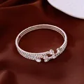 Detailed view of a vintage silver stretch open bracelet with shimmering rhinestone layers - Bangle / Silver