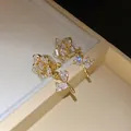 Exquisite 14k gold plated zircon flower clip-on earrings featuring elegant leaf details. - Clip-On Earrings / Gold