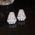Close-up of French vintage zircon pearl stud earrings with elegant luster and shine - French Retro Style / Silver