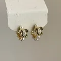 Detailed view of vintage gold flower earrings featuring elegant pearls and zircon stones. - Floral / Gold