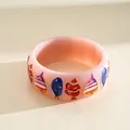 Detailed macro shot of a pink resin bangle featuring colorful tropical fish prints - Tropical Fish Print / Pink