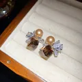 Detail view of retro zircon pearl earrings with water drop and square brown stones - Silver Earring Post Style / Brown