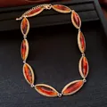 Detailed view of retro marquise-cut amber stones in a textured gold-tone necklace setting - Gold Brown