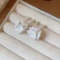 Close-up detail of elegant white floral stud earrings with silver pins in jewelry box - 925 Silver Needle Style (HE31426) / White