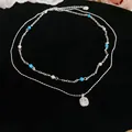 Close-up of a double-layer silver necklace with blue beads and a square zircon pendant. - Necklace-Silver-Double Layer