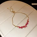Detail of gold adjustable bracelet with vibrant pink heart-shaped zircon stones - Gold-Rose Red