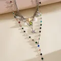 Detailed macro view of a layered silver necklace with starfish shell charms and pearls - Necklace (4-Piece Set) / Silver