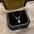 Elegant zircon flower pearl pendant necklace displayed in a premium blue velvet box - Pink Pearl / Silver