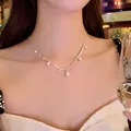 Close-up of elegant pearl and zircon necklace worn by a model in a luxury dining setting - Silver