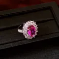Close-up detail of a vintage oval flower ring with a radiant magenta zircon center - Pink Oval Flower Style / Adjustable Open / Silver