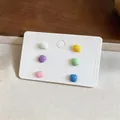 Detail view of a set of six colorful glossy square stud earrings on a white card. - Square Silver Post (HE33619) / 6-Piece Set / Colorful