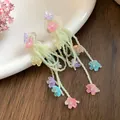 Detailed macro view of colorful shell flower tassel earrings with small green beads - Silver Post Shell Flower Tassel Style / Colorful