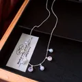 Close-up of elegant silver necklace with pearls and multi-colored gemstone charms - Round Pendant Style (HN12394) / Silver