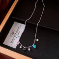 Detailed macro view of a vintage silver necklace with colorful heart and bead charms. - Heart Pendant Style (HN12394) / Silver