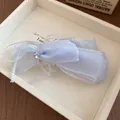 Close-up detail of a sweet light blue ribbon bow hair clip with a sparkling rhinestone - Banana Twist Clip / Blue