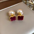 Close-up of vintage French style pearl stud earrings with burgundy velvet clover - Red-Coffee