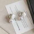 Macro detail of the elegant white geometric bead and round pearl on the silver hoop - Ear Buckle Style (HE32969) / Silver-White