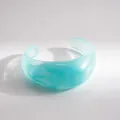 Detail view of a translucent blue marbled acrylic cuff bracelet with a chunky design - Sky Blue