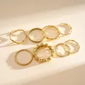 Collection of 8 minimalist gold geometric rings with textured and twisted designs - Set of 8 / Gold