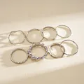 Macro view of minimalist 8-piece silver geometric ring set featuring varied textures - Set of 8 / Silver