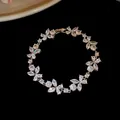 Close-up detail of a minimalist zircon flower bracelet, elegant jewelry for women - Flower Bracelet / Silver-White